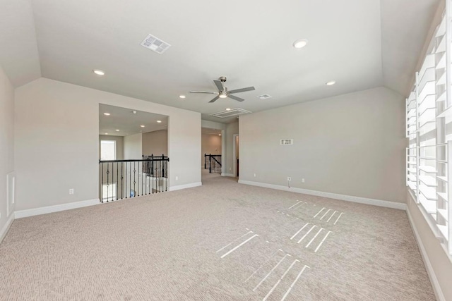 spare room featuring recessed lighting, visible vents, vaulted ceiling, and baseboards