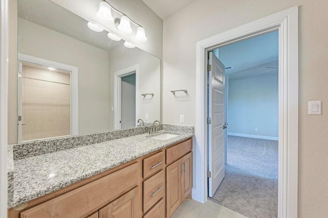 full bathroom with tile patterned flooring, baseboards, and vanity