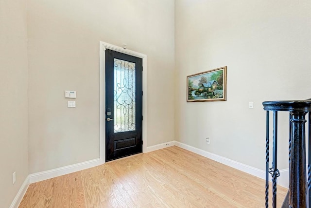 entrance foyer featuring baseboards and wood finished floors