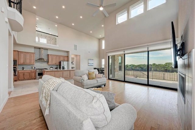 living room featuring a ceiling fan, recessed lighting, visible vents, and light wood-style floors