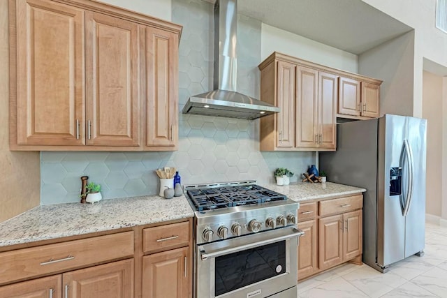 kitchen with wall chimney exhaust hood, light stone countertops, marble finish floor, stainless steel appliances, and backsplash