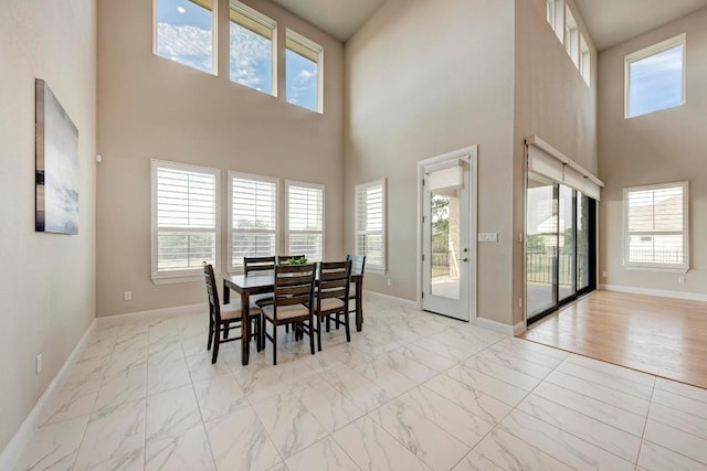 dining area with marble finish floor and baseboards