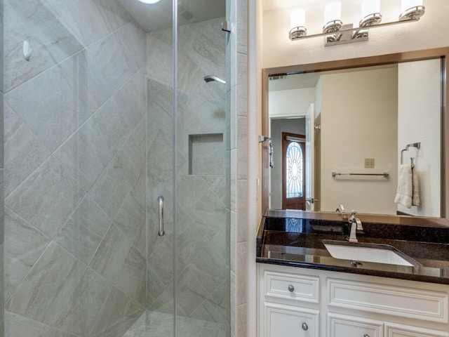 full bath featuring a shower stall and vanity