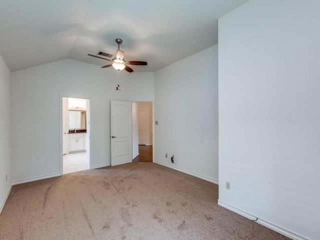 unfurnished bedroom featuring carpet, lofted ceiling, visible vents, a ceiling fan, and baseboards