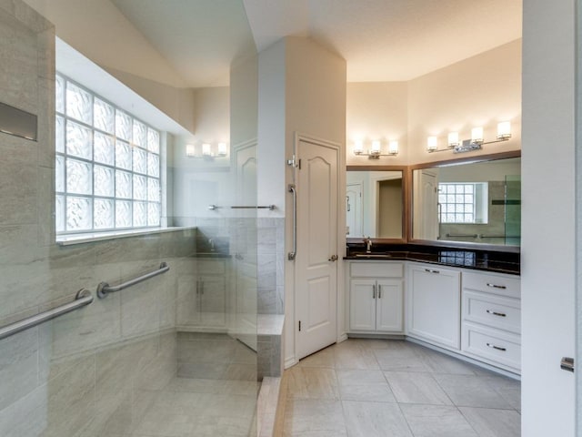 bathroom featuring a walk in shower, plenty of natural light, and vanity