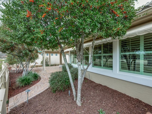 view of property exterior with a patio area and fence