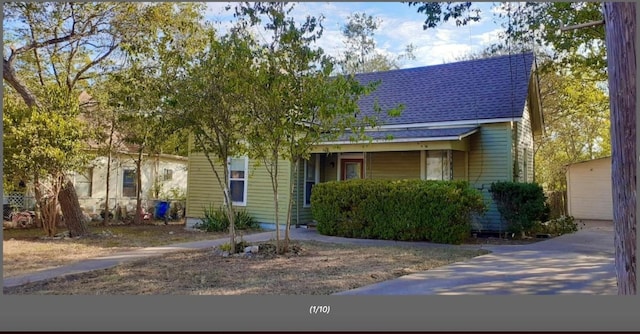 view of front of home featuring roof with shingles