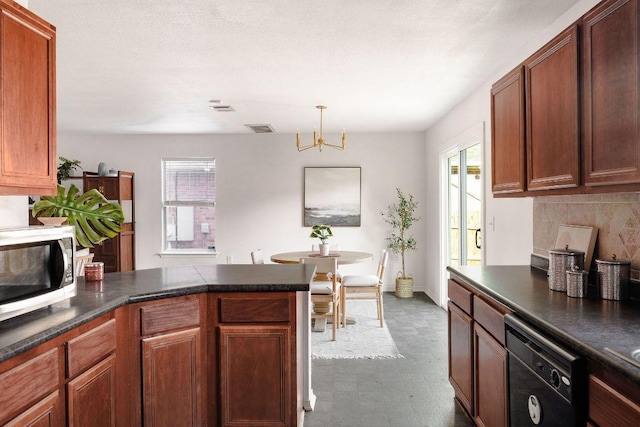 kitchen featuring a peninsula, visible vents, black dishwasher, stainless steel microwave, and dark countertops