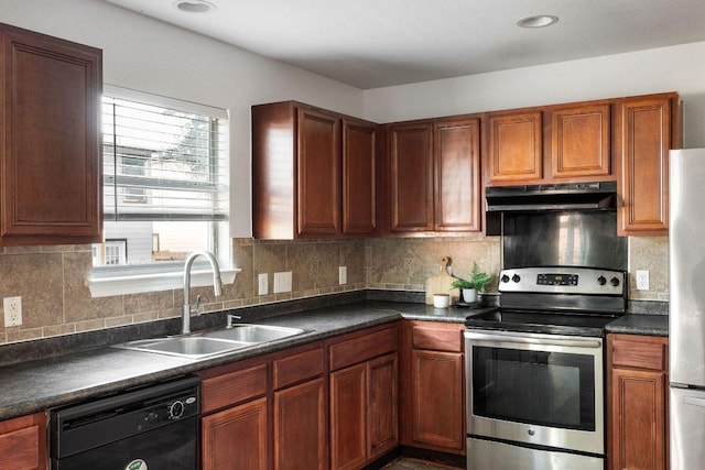 kitchen featuring stainless steel appliances, dark countertops, tasteful backsplash, a sink, and under cabinet range hood