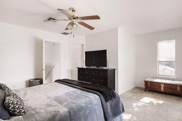 carpeted bedroom with baseboards, visible vents, and a ceiling fan