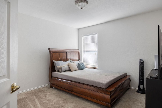 bedroom with carpet flooring and baseboards