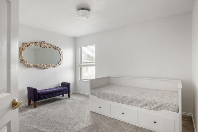 bedroom with carpet flooring and baseboards