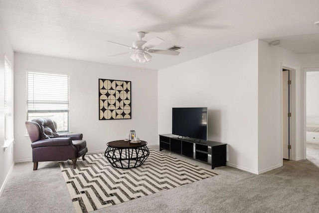 living room featuring a ceiling fan, carpet, visible vents, and baseboards