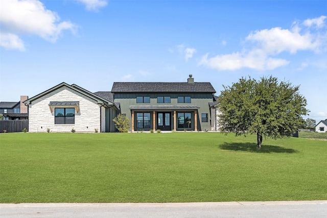 view of front of property featuring a chimney and a front lawn