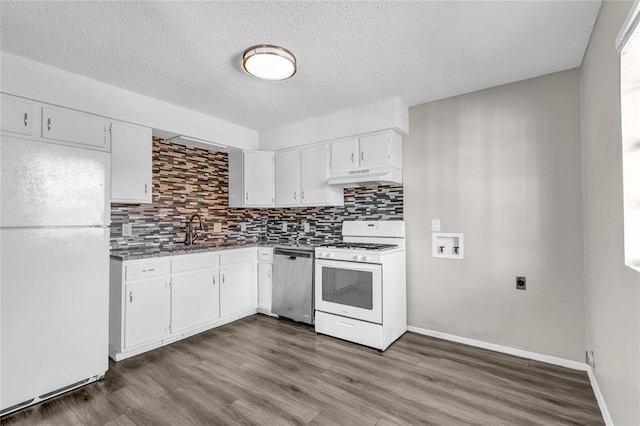 kitchen with white appliances, white cabinets, dark wood-style floors, under cabinet range hood, and backsplash