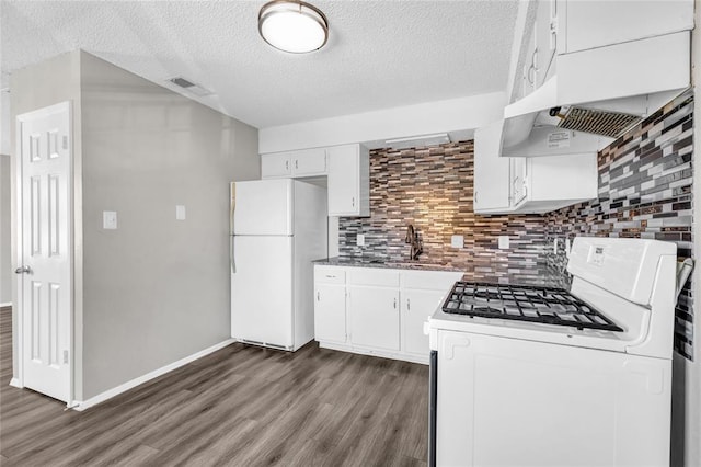 kitchen with dark wood finished floors, decorative backsplash, white cabinets, a sink, and white appliances