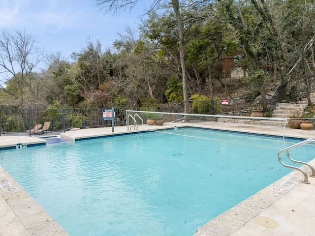 pool featuring a patio area and fence