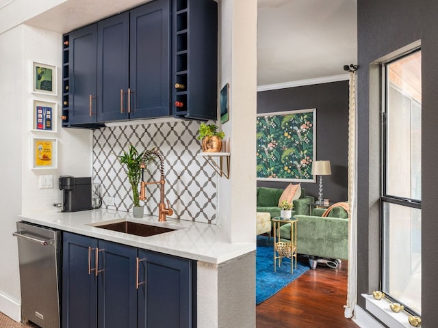 kitchen with blue cabinets, a sink, light countertops, stainless steel dishwasher, and open shelves