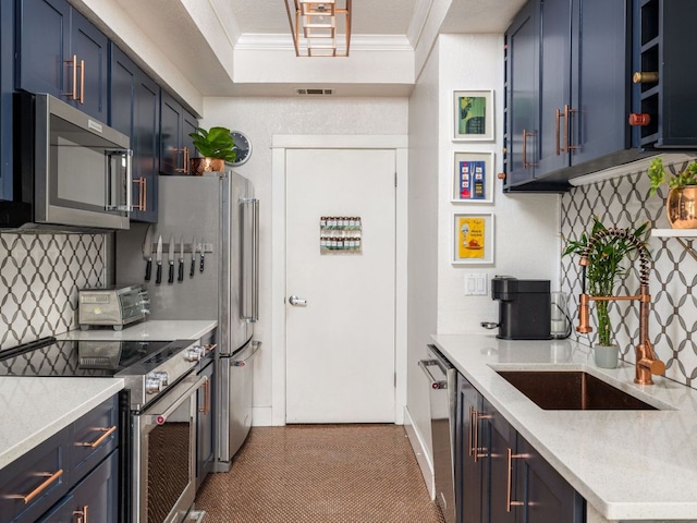 kitchen with visible vents, appliances with stainless steel finishes, ornamental molding, blue cabinets, and backsplash