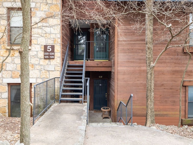 property entrance featuring stone siding