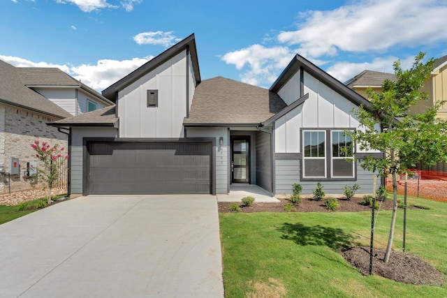 9908 Ephemeral Dr, Manor, TX 78653 - view of front facade with board and batten siding, a garage, concrete driveway, and a front lawn