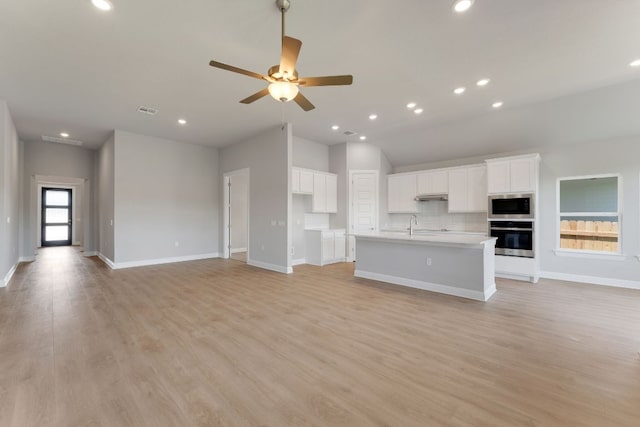 9908 Ephemeral Dr, Manor, TX 78653 - unfurnished living room featuring a ceiling fan, light wood-style flooring, and recessed lighting