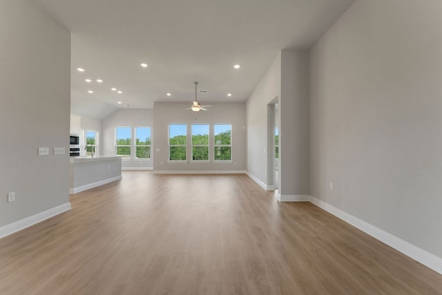 9908 Ephemeral Dr, Manor, TX 78653 - unfurnished living room with a ceiling fan, recessed lighting, light wood finished floors, and lofted ceiling