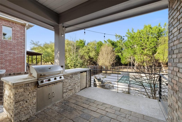 view of patio with fence and area for grilling