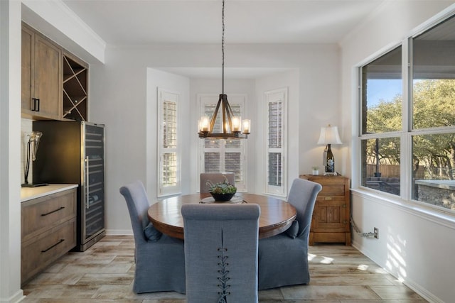 22128 Rose Grass Ln, Spicewood, TX 78669 - dining area with a chandelier, plenty of natural light, light wood-style floors, and baseboards
