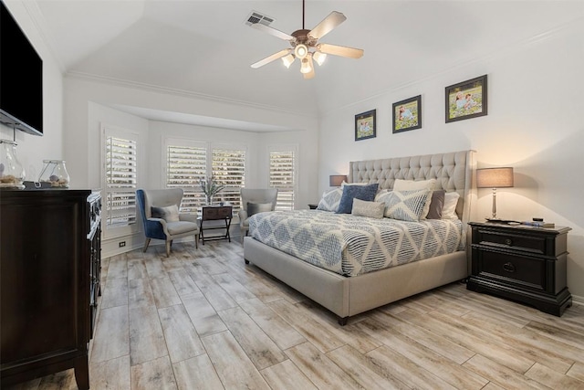 bedroom with lofted ceiling, visible vents, light wood-style flooring, and a ceiling fan