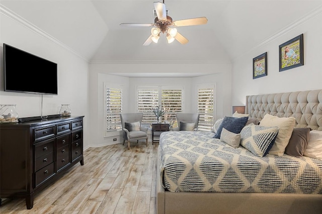 bedroom with crown molding, lofted ceiling, light wood-style floors, a ceiling fan, and baseboards