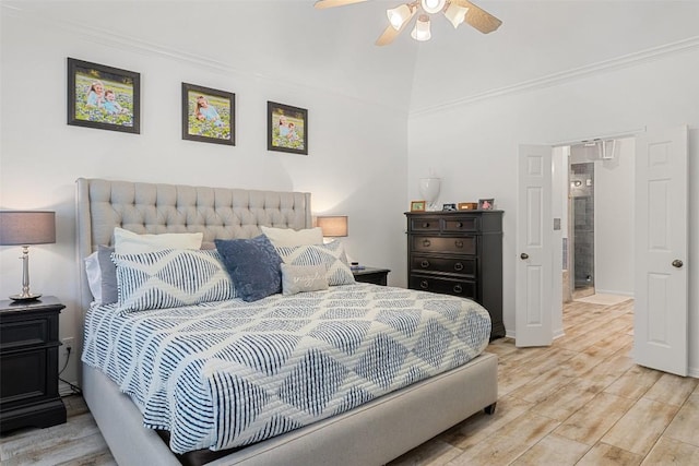 bedroom featuring lofted ceiling, a ceiling fan, wood finished floors, and ornamental molding