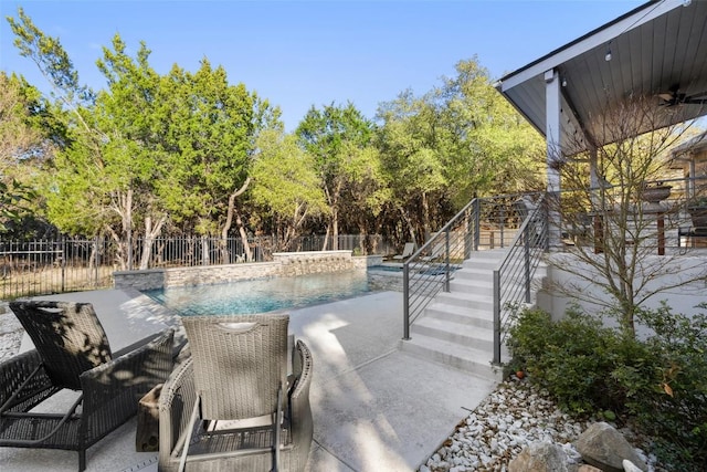 view of swimming pool featuring stairs, fence, a fenced in pool, and a patio