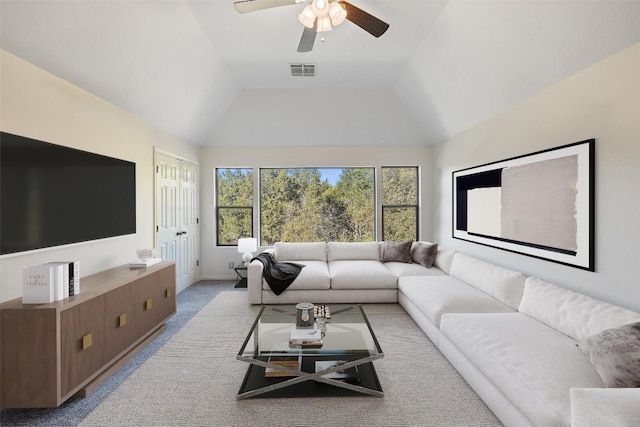 living area featuring light carpet, visible vents, baseboards, lofted ceiling, and ceiling fan