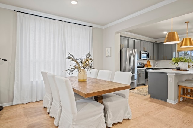 dining area with ornamental molding, recessed lighting, baseboards, and light wood finished floors