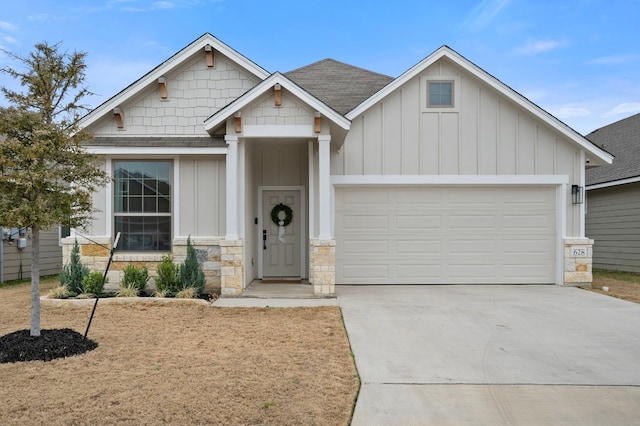 craftsman-style house with a garage, concrete driveway, and board and batten siding