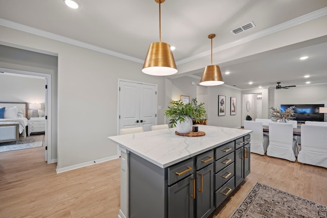 kitchen featuring crown molding, light wood finished floors, recessed lighting, visible vents, and open floor plan