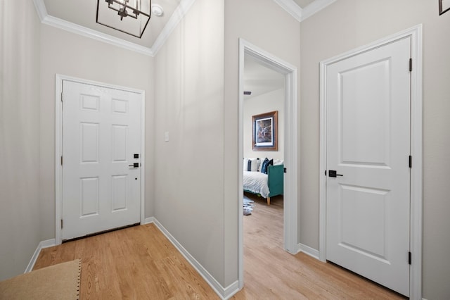 entrance foyer featuring light wood-style flooring, ornamental molding, and baseboards