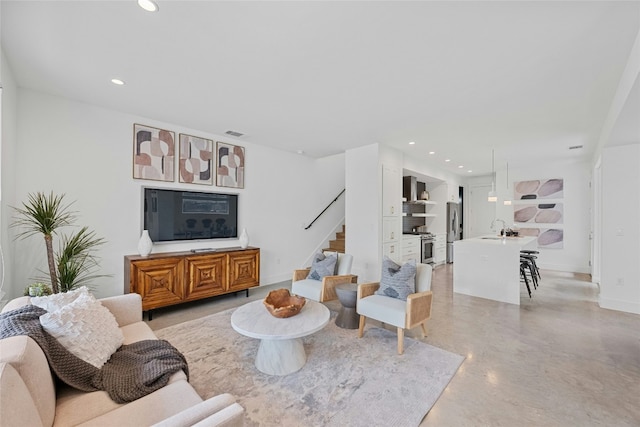 living room featuring recessed lighting, visible vents, stairway, concrete floors, and baseboards