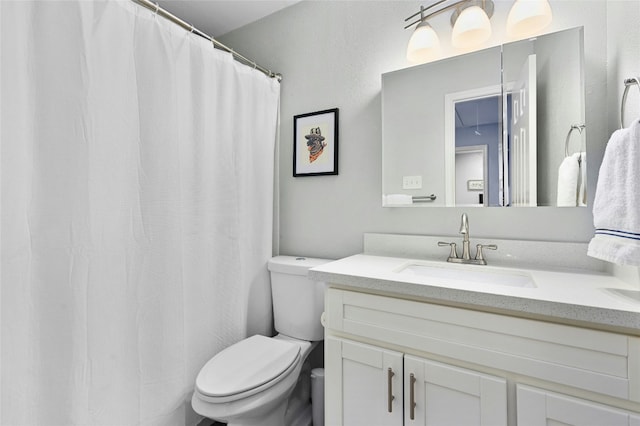 full bathroom with toilet and vanity