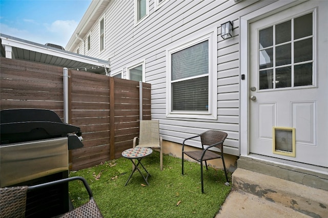 view of patio with a grill and fence