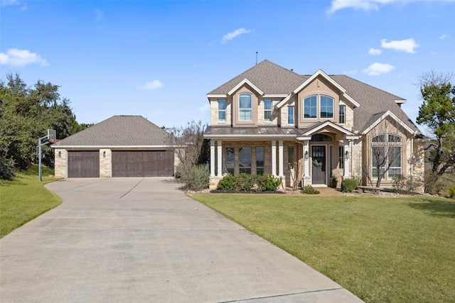 view of front of home with a garage, stone siding, a front lawn, and roof with shingles