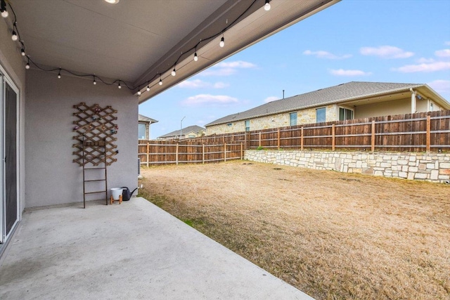 view of yard featuring a patio area and a fenced backyard