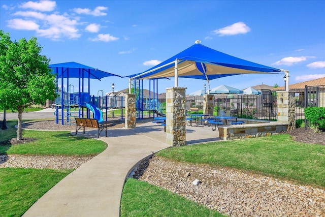 community playground featuring fence and a lawn