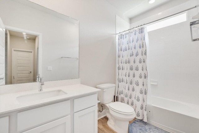 bathroom featuring toilet, shower / bathtub combination with curtain, wood finished floors, and vanity