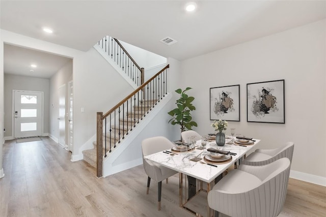 dining space with recessed lighting, visible vents, baseboards, stairs, and light wood finished floors