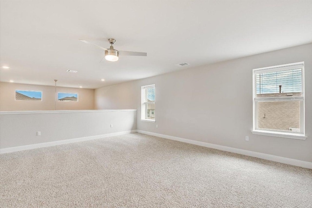 carpeted spare room with a ceiling fan, recessed lighting, visible vents, and baseboards