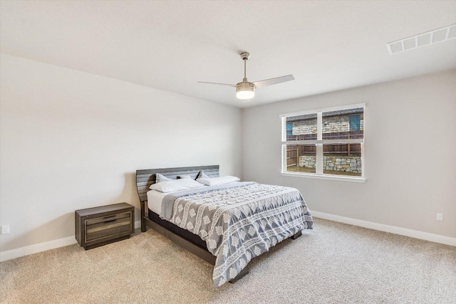 bedroom featuring ceiling fan, carpet flooring, visible vents, and baseboards