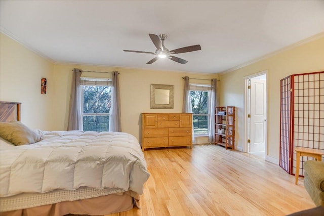 bedroom with light wood-type flooring, ceiling fan, baseboards, and crown molding