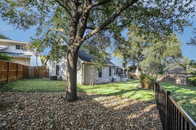 view of yard featuring a fenced backyard and central AC unit